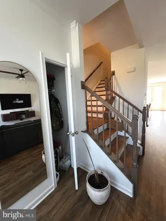 a view of a hardwood floor and staircase