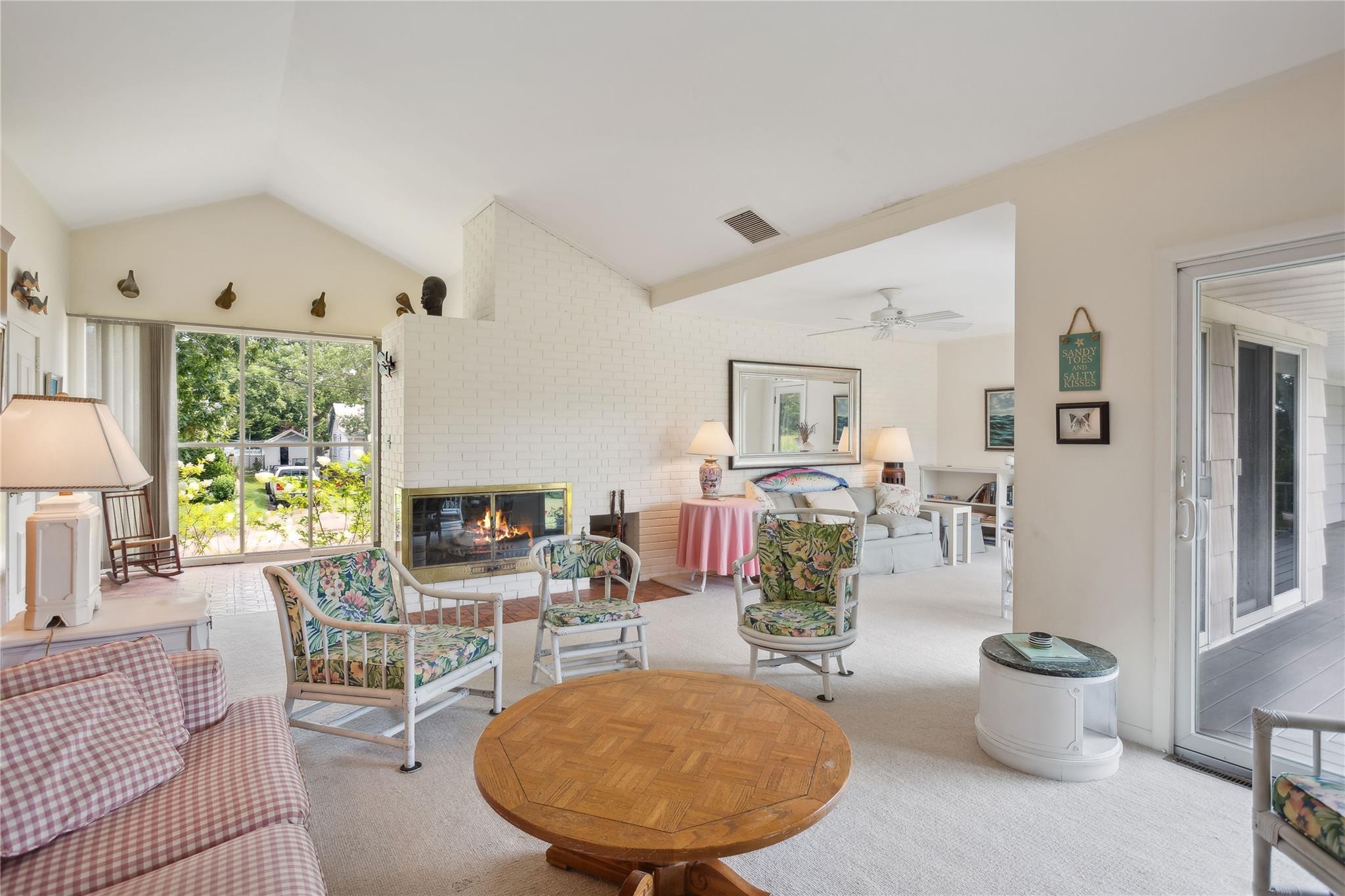 33 Beach Road Laurel, NY 11948 - Photo 11 of 38 a living room with furniture a flat screen tv and a large window