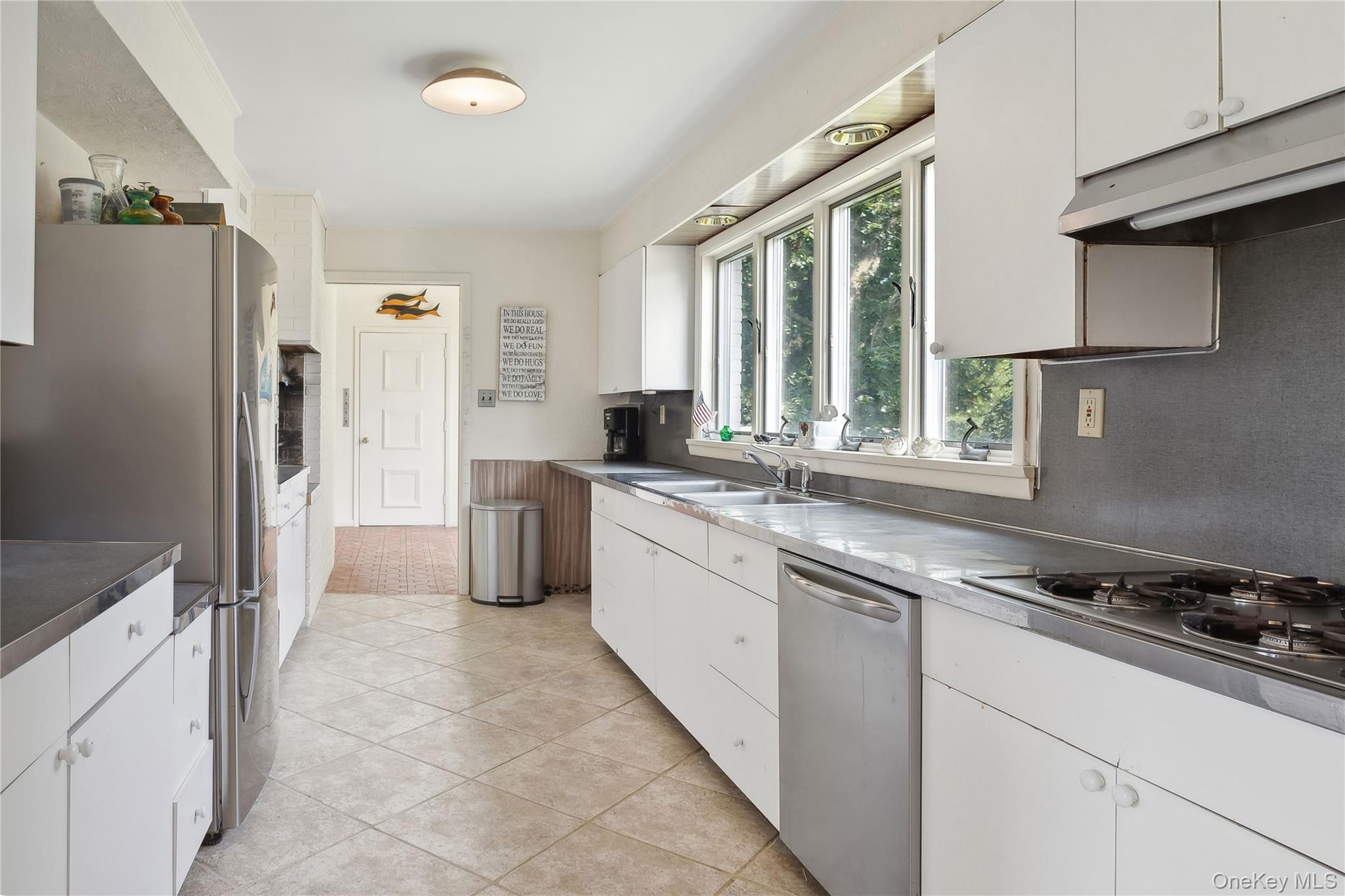 33 Beach Road Laurel, NY 11948 - Photo 12 of 38 a kitchen with granite countertop a refrigerator stove top oven and sink