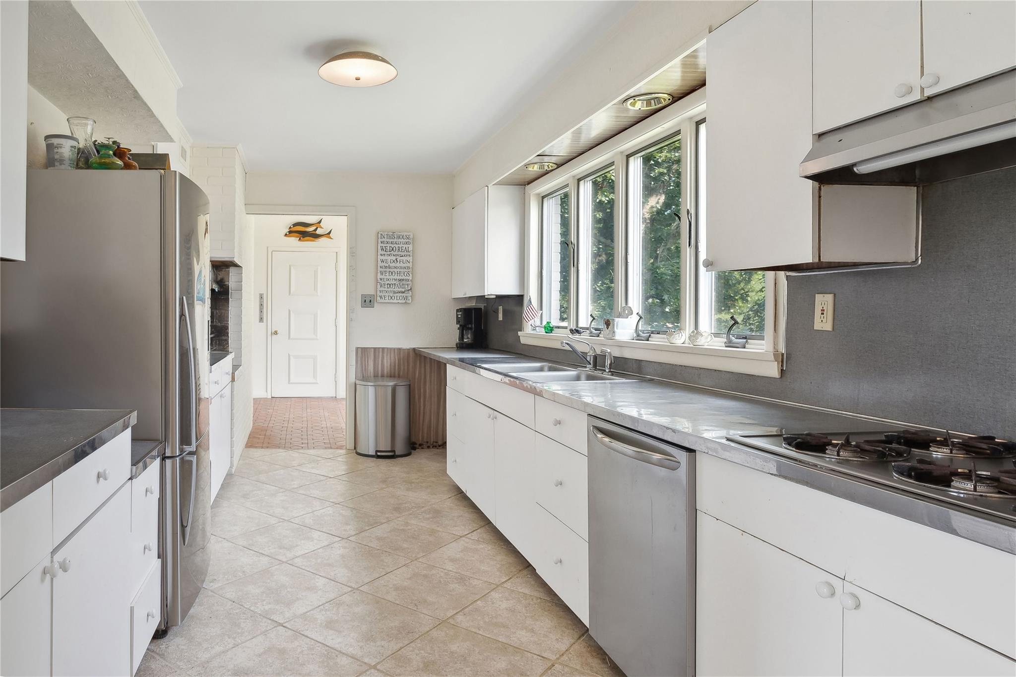 33 Beach Road Laurel, NY 11948 - Photo 12 of 38 a kitchen with granite countertop a refrigerator stove top oven and sink