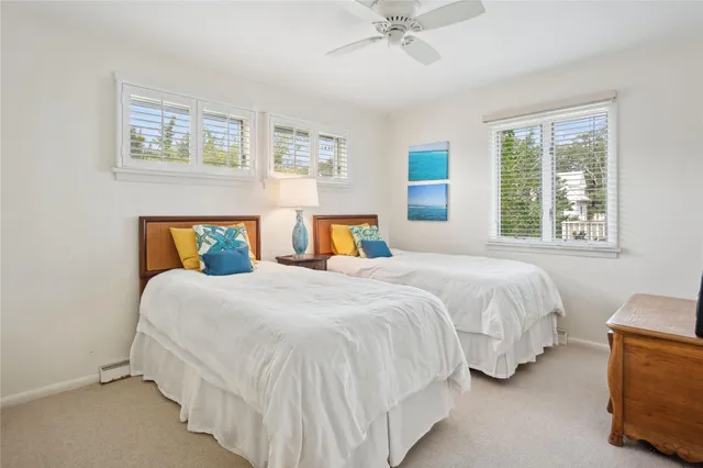 a bedroom with two beds and a chandelier