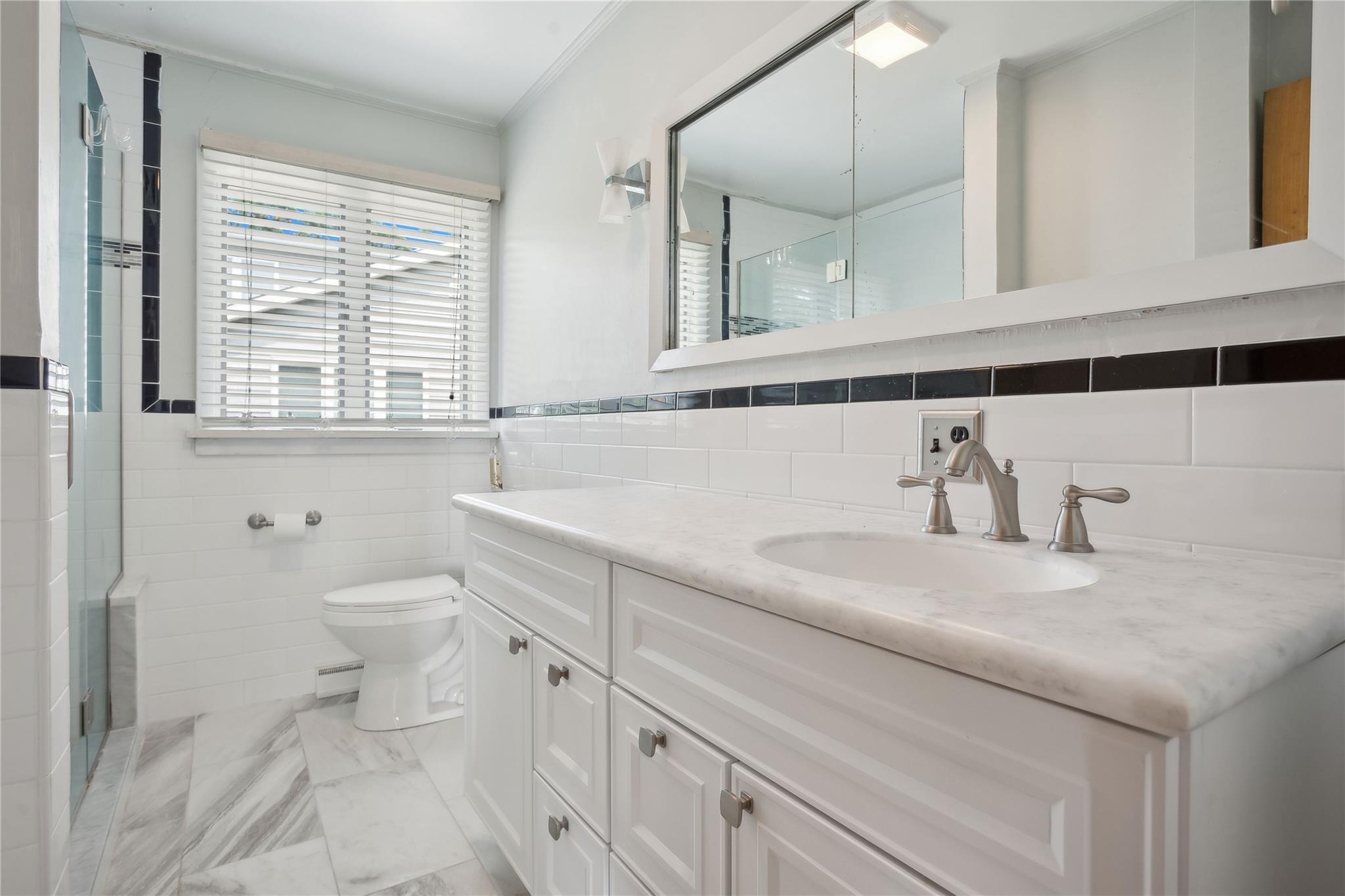 33 Beach Road Laurel, NY 11948 - Photo 16 of 38 a bathroom with a sink and a toilet