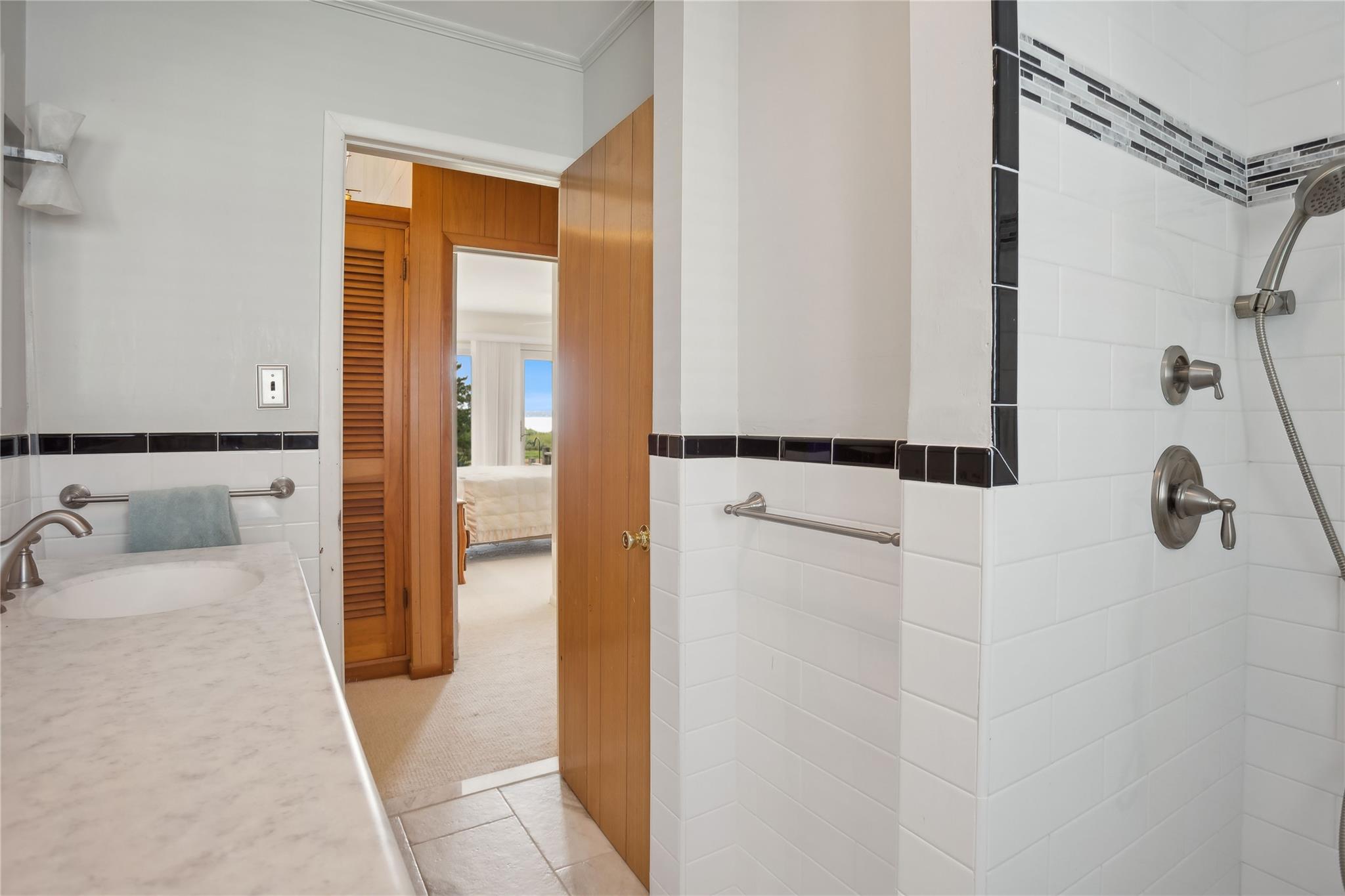 33 Beach Road Laurel, NY 11948 - Photo 17 of 38 a en suite bathroom with a sink and a shower