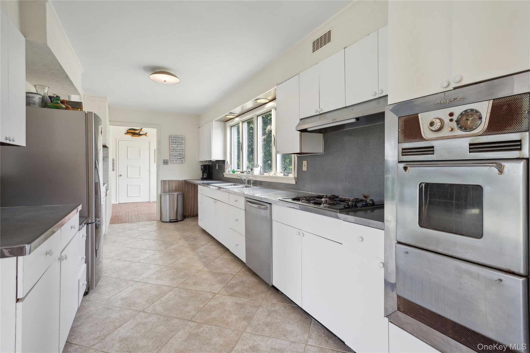 33 Beach Road Laurel, NY 11948 - Photo 24 of 38 a kitchen with stainless steel appliances a stove a refrigerator and a sink