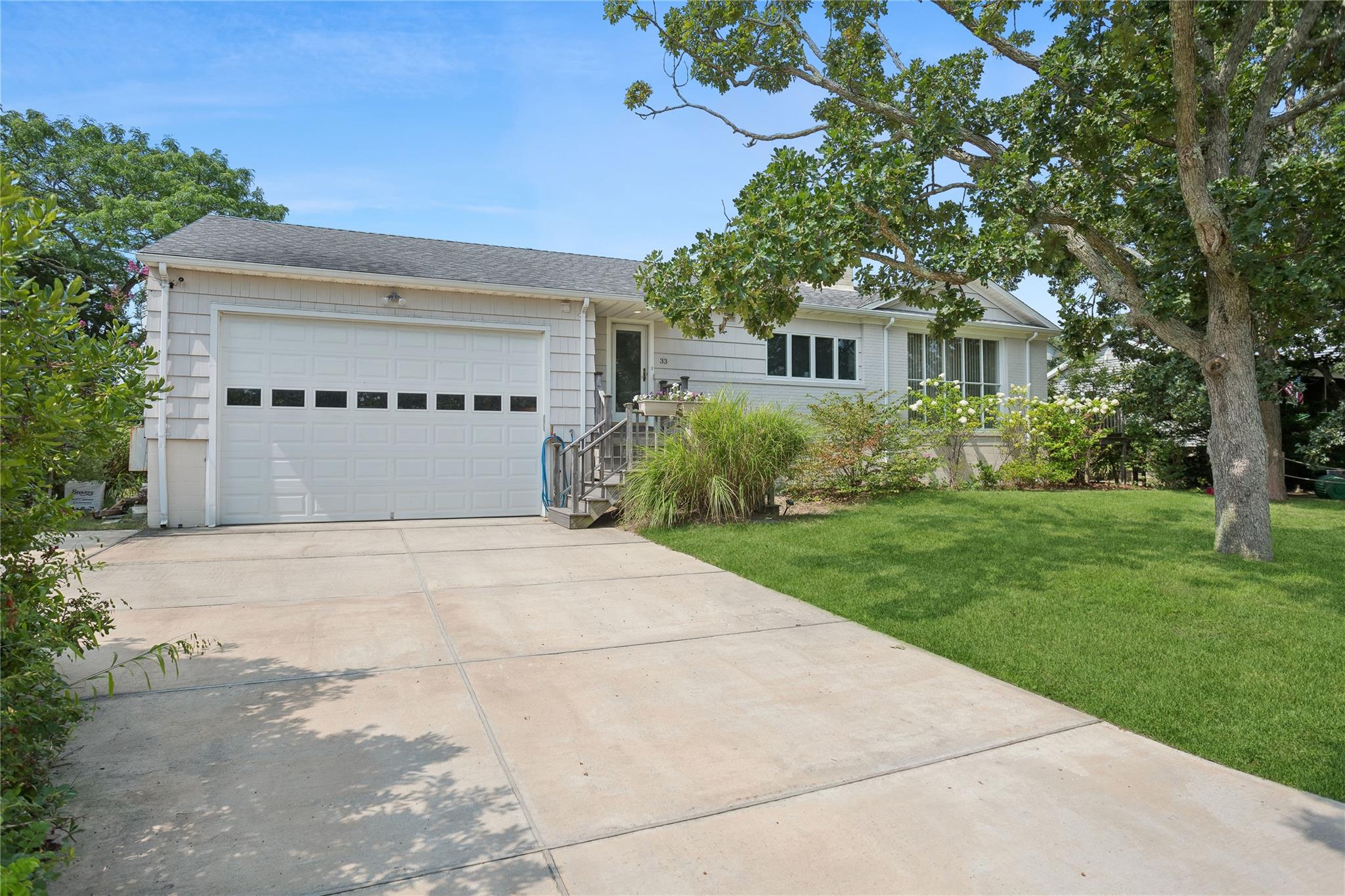 33 Beach Road Laurel, NY 11948 - Photo 35 of 38 a front view of a house with a yard and trees