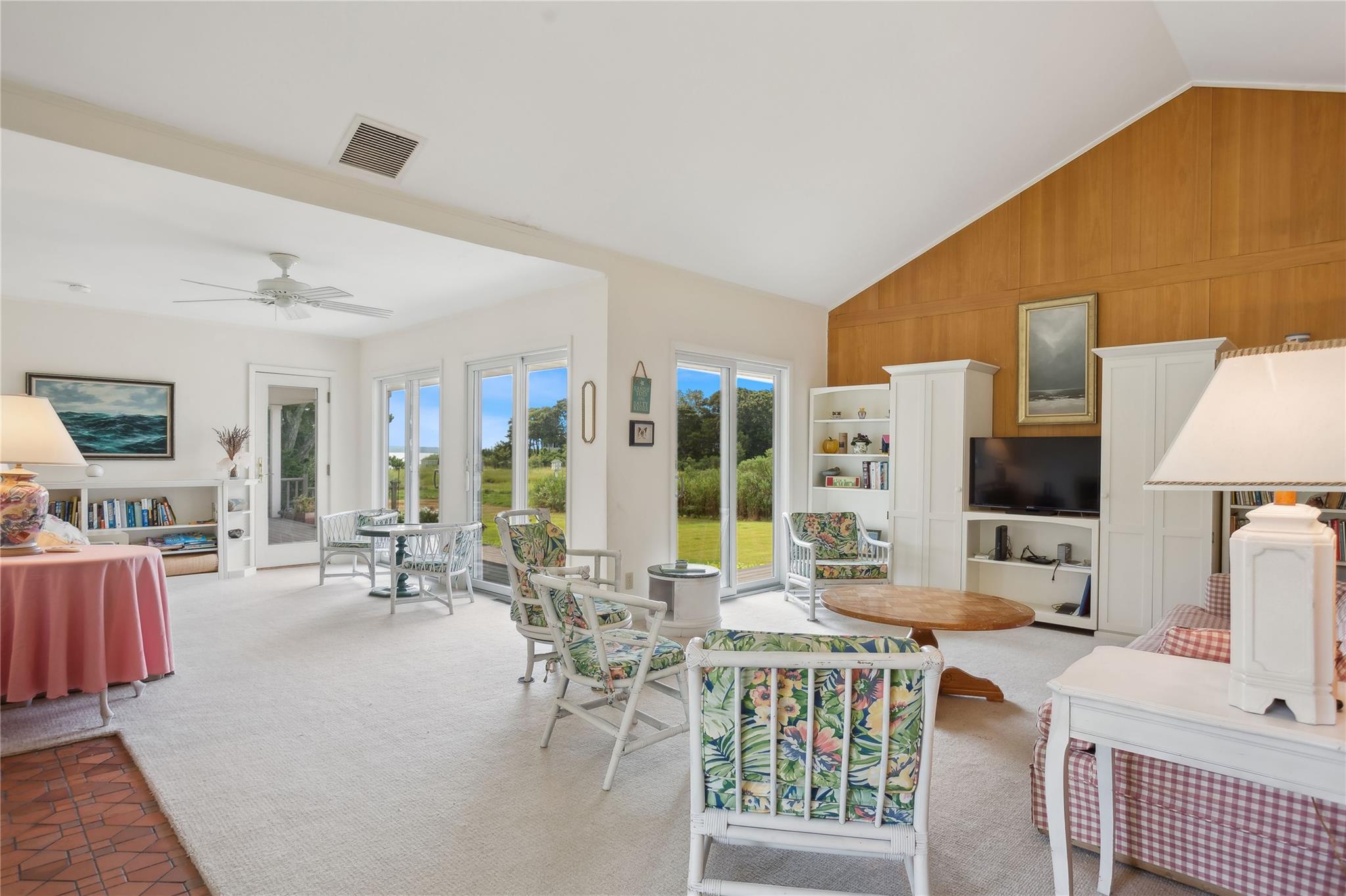 33 Beach Road Laurel, NY 11948 - Photo 4 of 38 a living room with furniture a flat screen tv and a large window