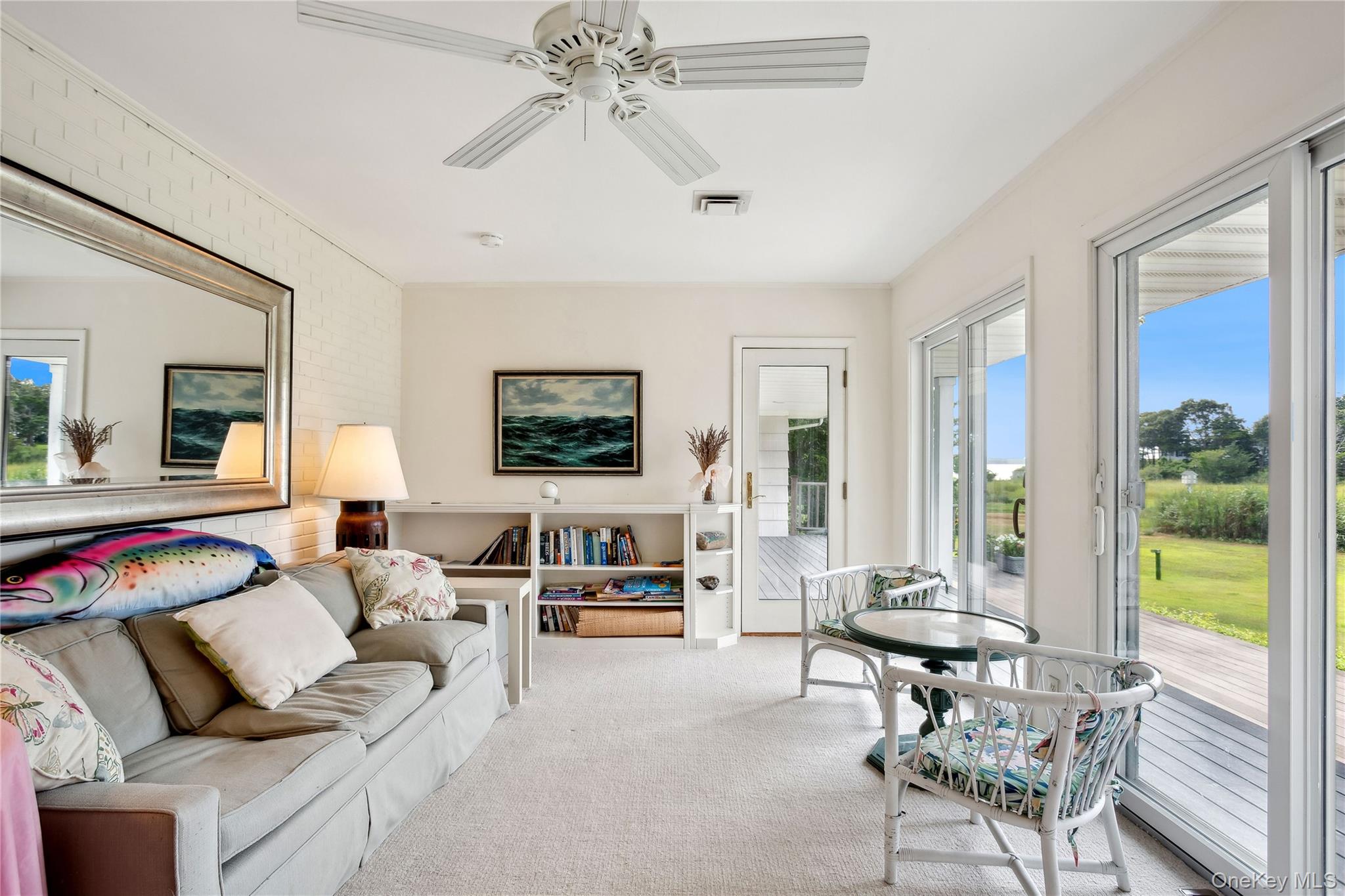 33 Beach Road Laurel, NY 11948 - Photo 6 of 38 a living room with furniture and a large window