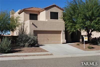 1118 South Riparian Avenue Tucson, AZ 85748 - Photo 1 of 13 a front view of a house with a garage