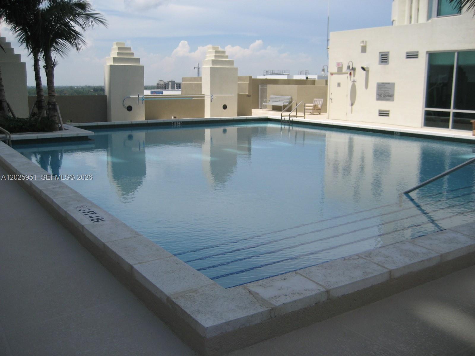 9066 Southwest 73rd Court, Unit 1802 Miami, FL 33156 - Photo 11 of 12 a view of a swimming pool with outdoor seating and yard