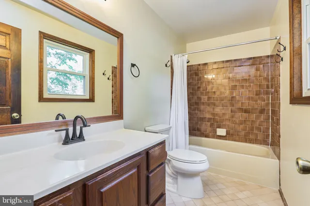 a view of a hallway with a dining room and windows