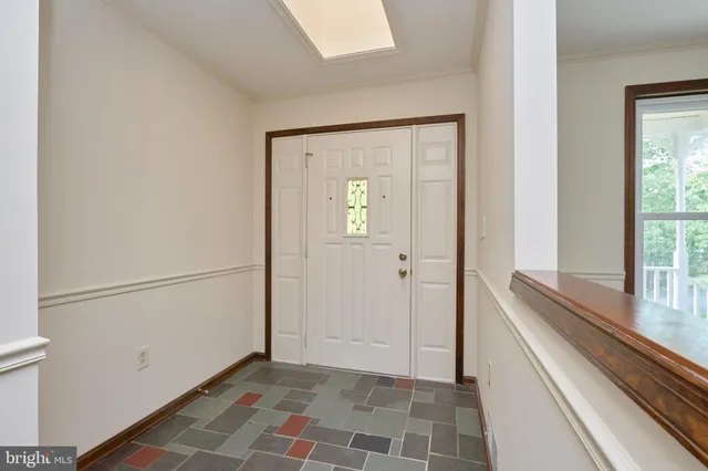 a view of an empty room with a fireplace and a window