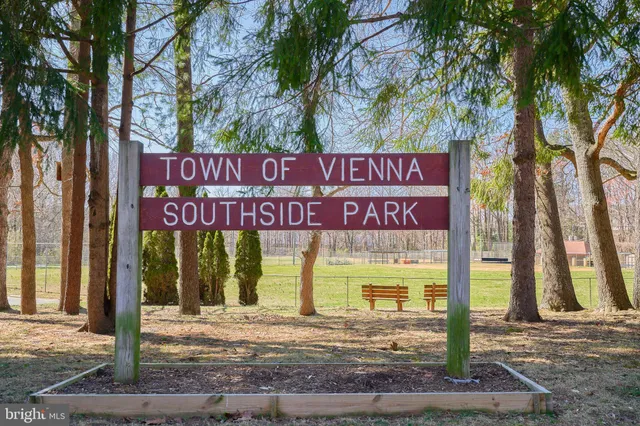 a front view of a house with a yard and fountain in middle