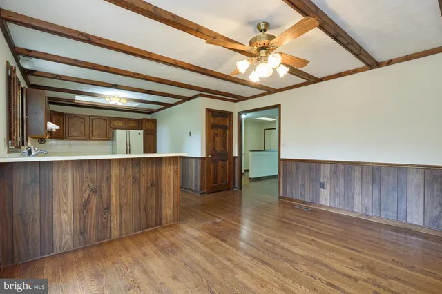 a kitchen with stainless steel appliances granite countertop a stove a sink dishwasher a refrigerator and a microwave oven