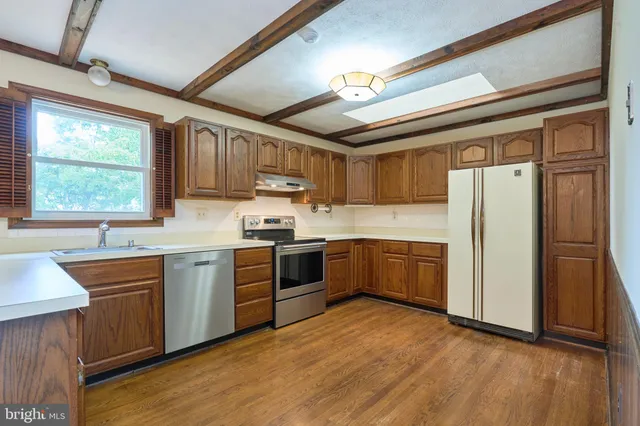 a kitchen with stainless steel appliances granite countertop a stove and a sink