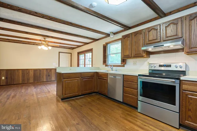a kitchen with granite countertop a stove and a sink