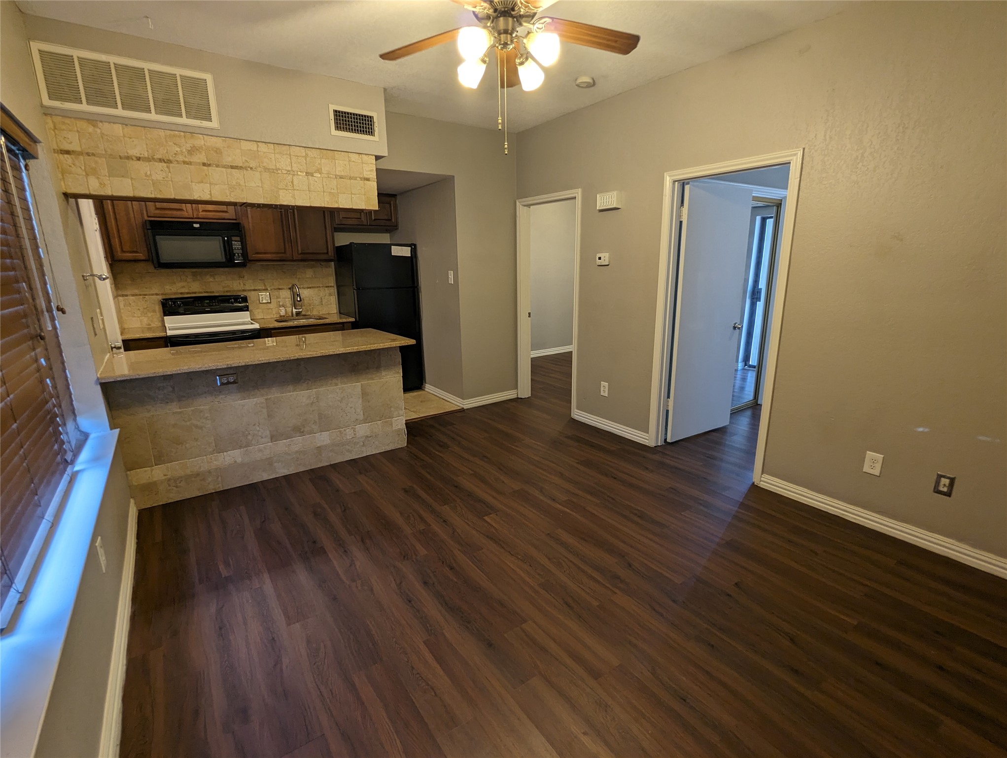 601 Nelray Boulevard, Unit 3 Austin, TX 78751 - Photo 2 of 12 a view of kitchen and hall with wooden floor