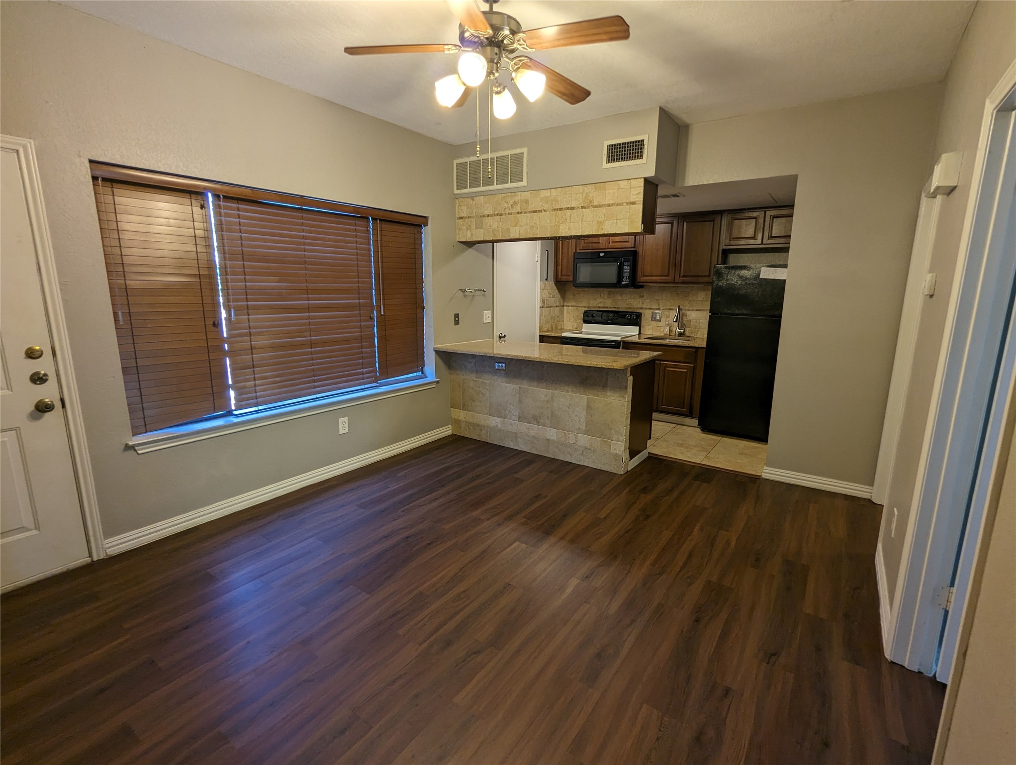 601 Nelray Boulevard, Unit 3 Austin, TX 78751 - Photo 3 of 12 wooden floor in an empty room with a window