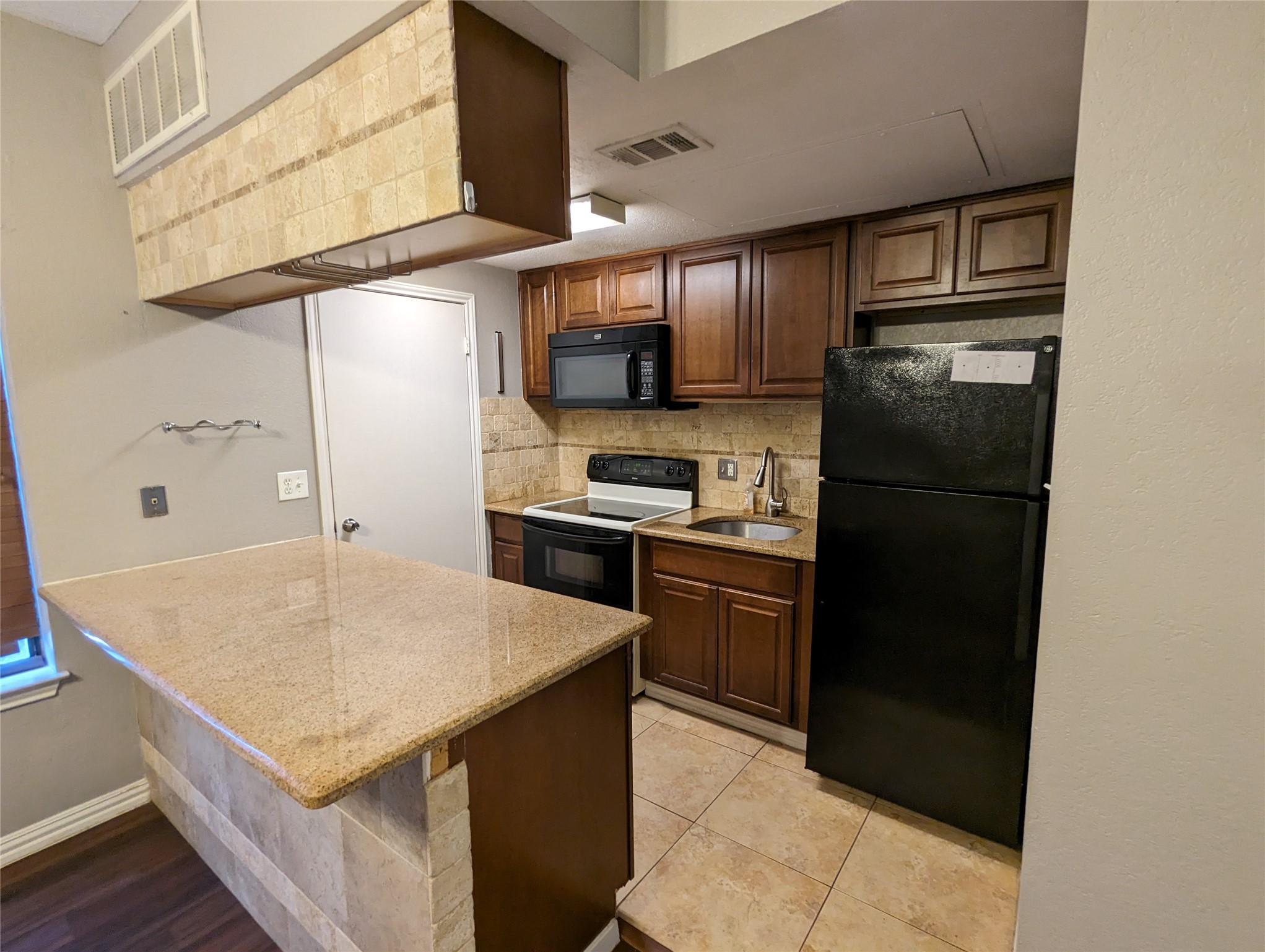 601 Nelray Boulevard, Unit 3 Austin, TX 78751 - Photo 4 of 12 a kitchen with a refrigerator a sink and a refrigerator
