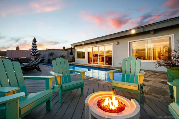 a view of a living room and deck with furniture