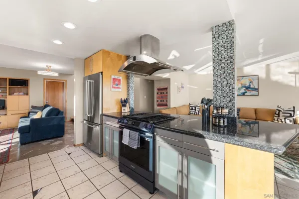 a kitchen with stainless steel appliances granite countertop a stove a sink and a refrigerator