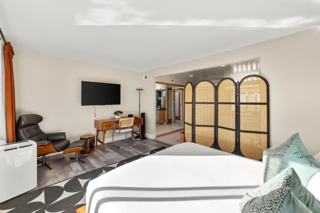 a bedroom with a bed and wooden floor