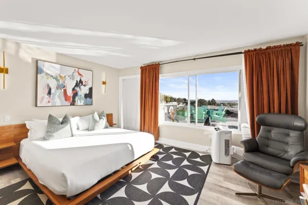 a large white kitchen with a sink and stainless steel appliances