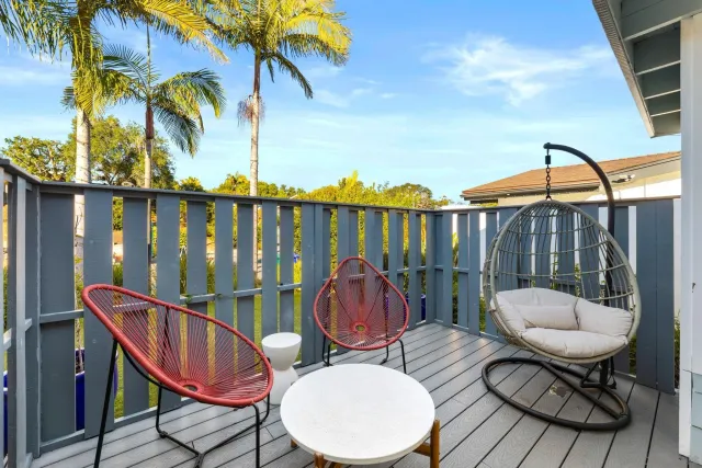 a bedroom with a bed and painting on the wall