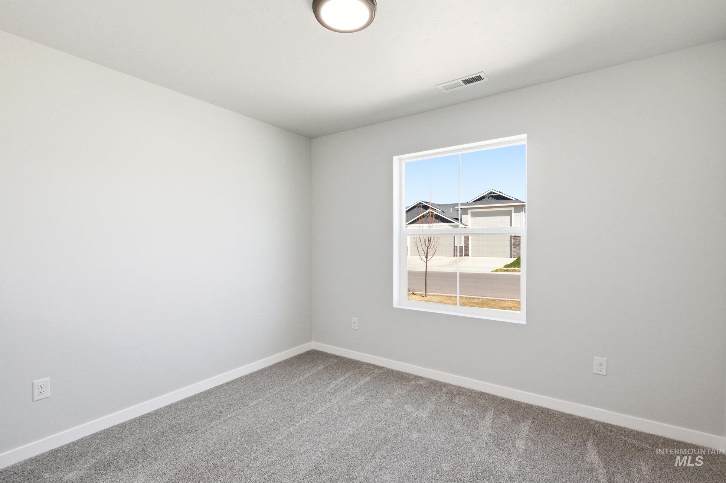 12877 Decatur Street Nampa, ID 83651 - Photo 17 of 22 Bright room with a neutral color palette, featuring a large window providing ample natural light