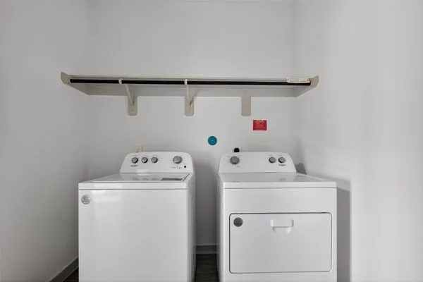 a living room with stainless steel appliances kitchen island granite countertop a refrigerator stove oven and a sink with dishwasher