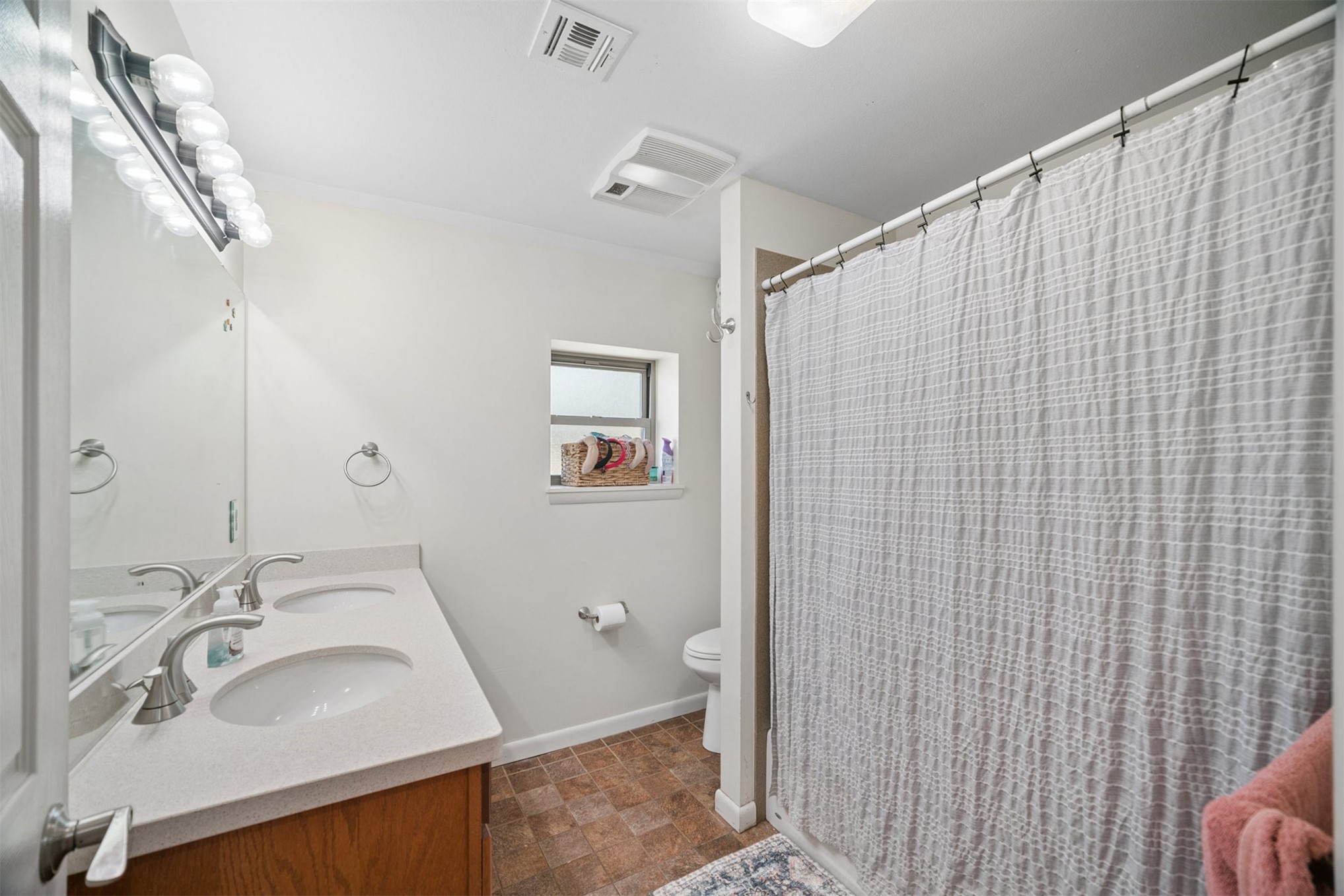 49301 South 360 Road Pawnee, OK 74058 - Photo 13 of 44 Dual vanity with white undermount sinks, light-toned countertop, and brushed nickel fixtures