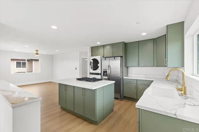 a kitchen with a sink cabinets and stainless steel appliances