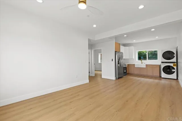 a kitchen with a refrigerator sink and cabinets