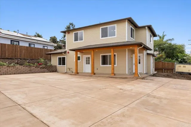 a view of a white house with a outdoor space