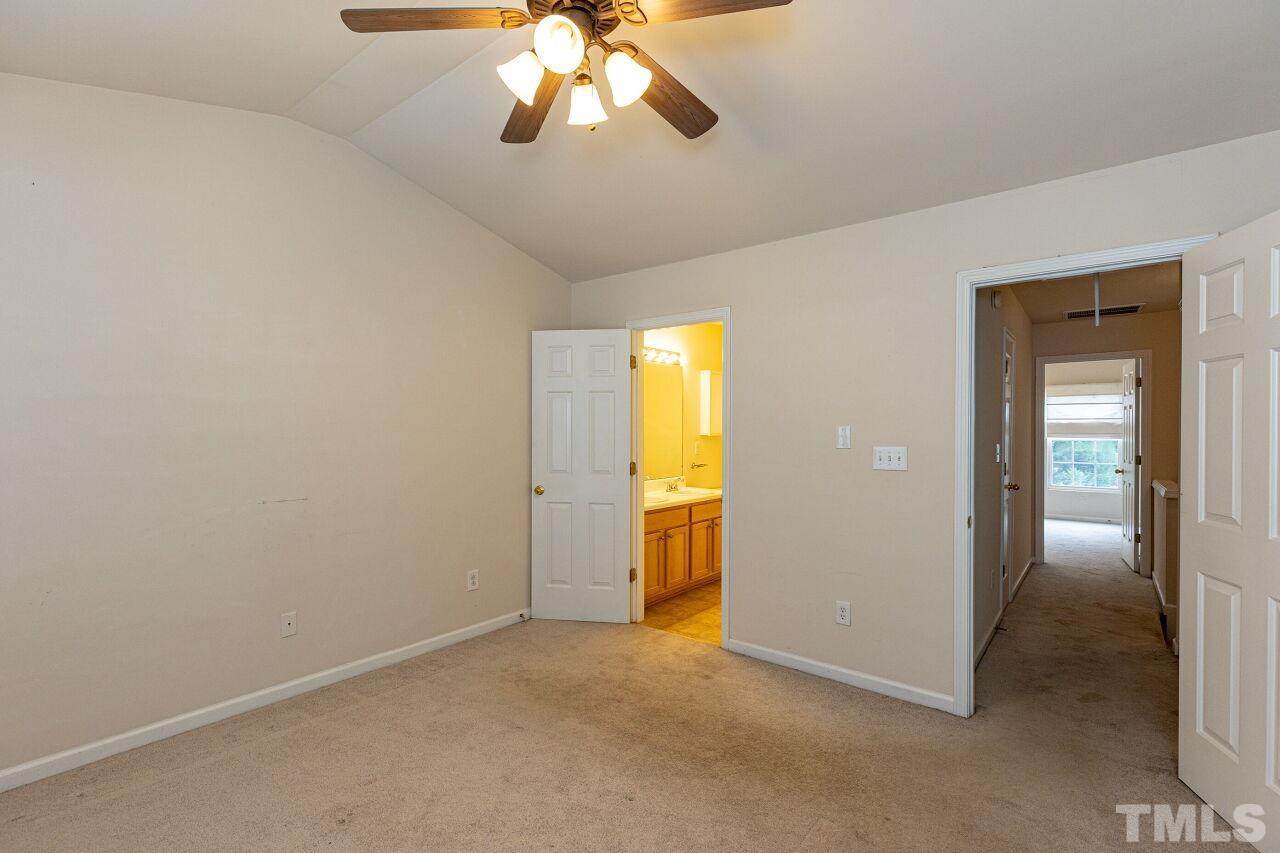 1730 Sorrell Brook Way Raleigh, NC 27609 - Photo 17 of 30 an empty room with chandelier fan