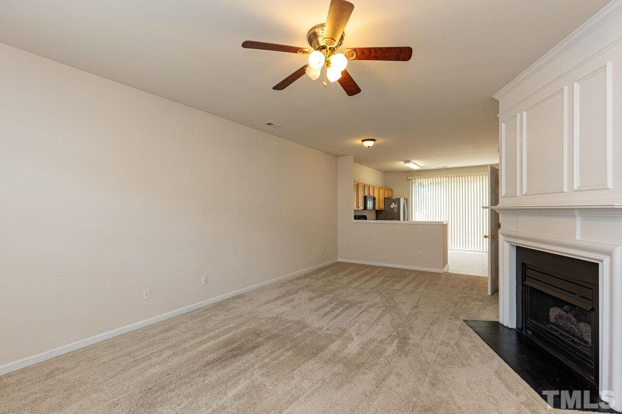 1730 Sorrell Brook Way Raleigh, NC 27609 - Photo 4 of 30 a view of a room a ceiling fan a fireplace and entryway