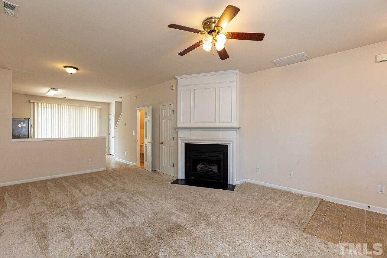 1730 Sorrell Brook Way Raleigh, NC 27609 - Photo 6 of 30 a view of a livingroom with a ceiling fan and a fireplace