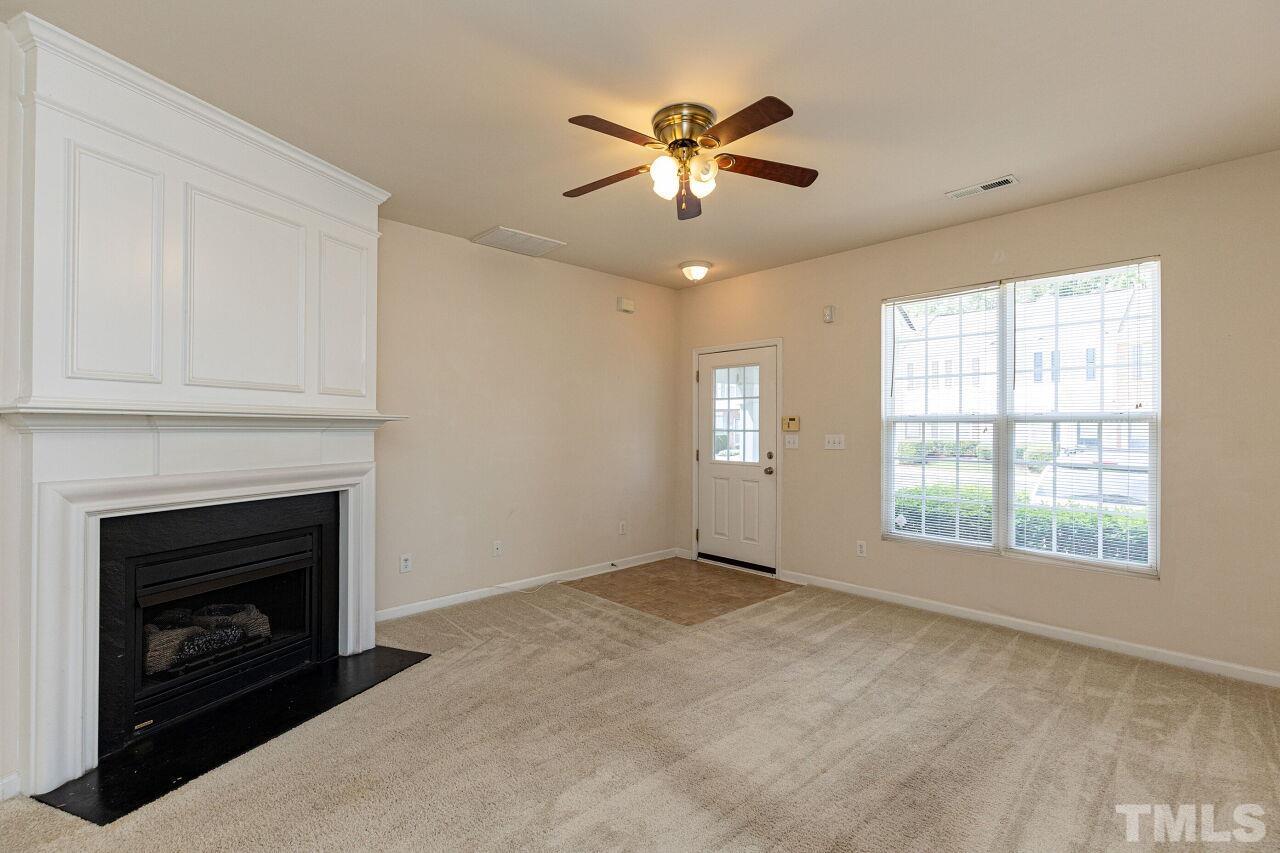 1730 Sorrell Brook Way Raleigh, NC 27609 - Photo 7 of 30 a view of an empty room with window and fire place