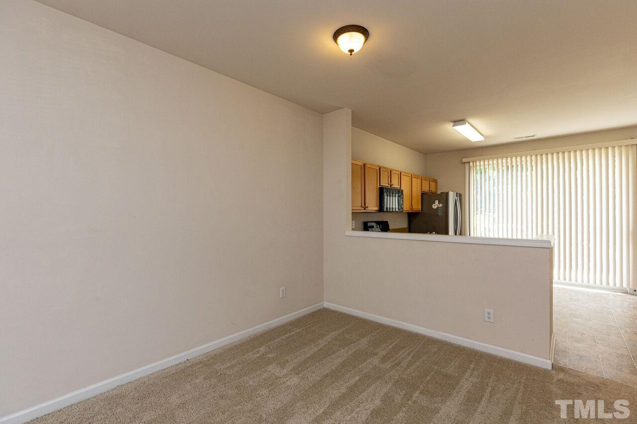 1730 Sorrell Brook Way Raleigh, NC 27609 - Photo 8 of 30 wooden floor in an empty room with a window