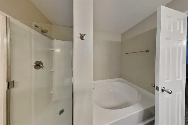 a bathroom with a tub shower and a sink