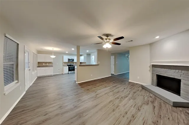 a view of a kitchen and an empty room
