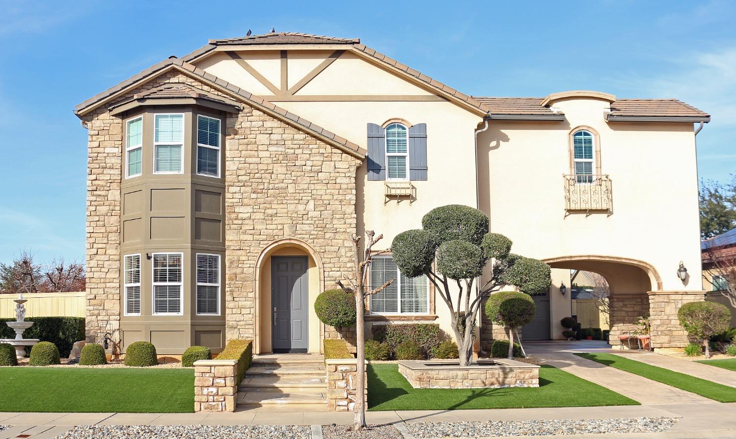 a front view of a house with garden