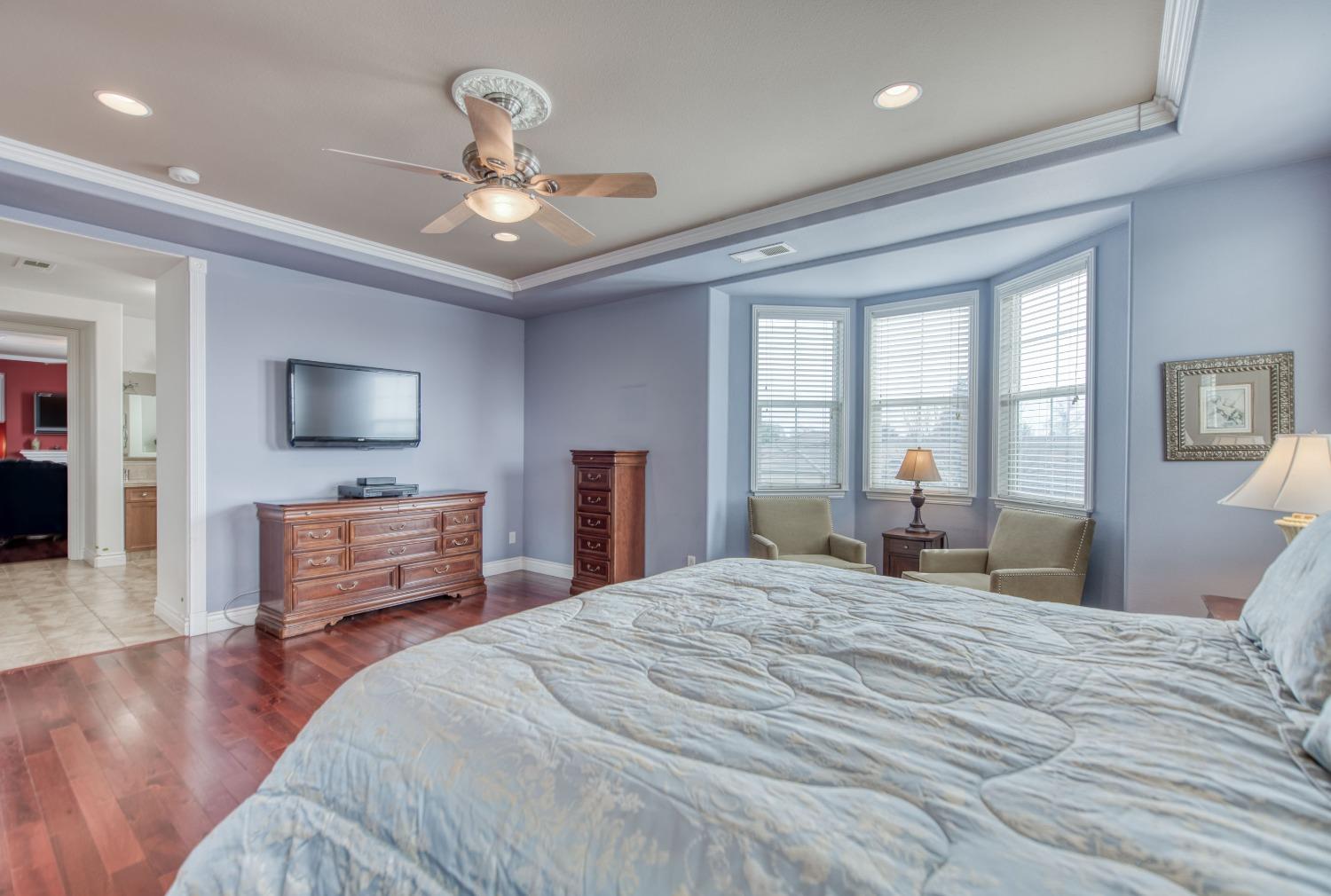 3207 Dennis Avenue Clovis, CA 93619 - Photo 18 of 55 a bedroom with a bed and wooden floor