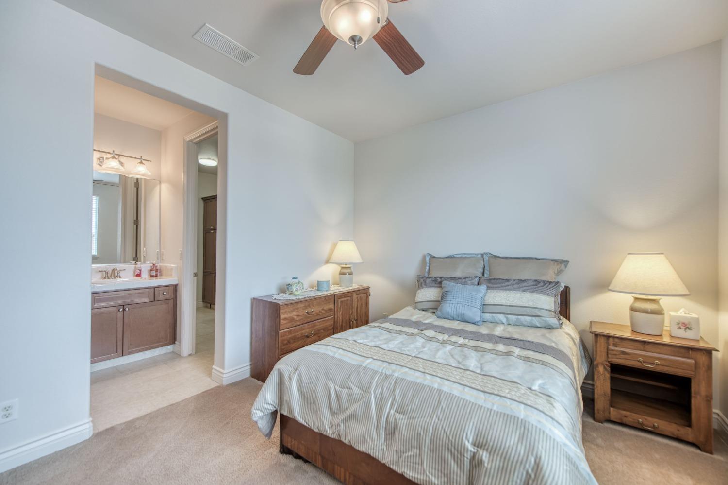 3207 Dennis Avenue Clovis, CA 93619 - Photo 28 of 55 a bedroom with a bed and a chandelier