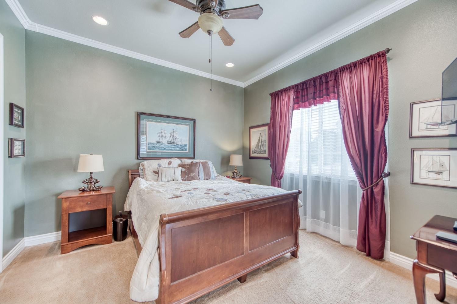 3207 Dennis Avenue Clovis, CA 93619 - Photo 8 of 55 a bedroom with a bed and a chandelier