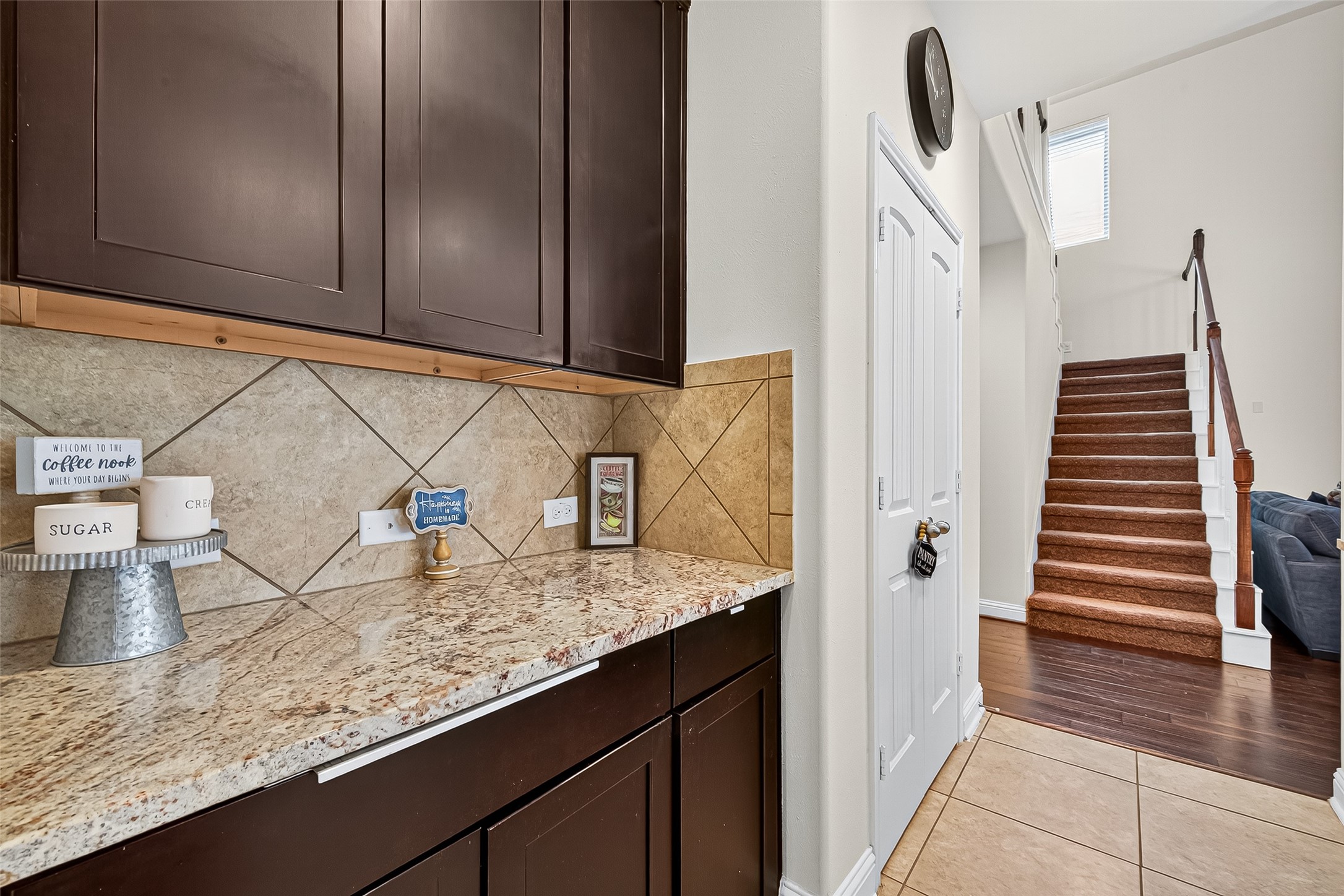 8107 Lockridge Terrace Lane Cypress, TX 77433 - Photo 15 of 50 Great area for a coffee station or wine bar, this beautifully finished butler’s pantry features luxurious granite countertops and rich cabinetry. Its location between the kitchen and dining area makes it the ideal spot for entertaining or enjoying quiet morning rituals.