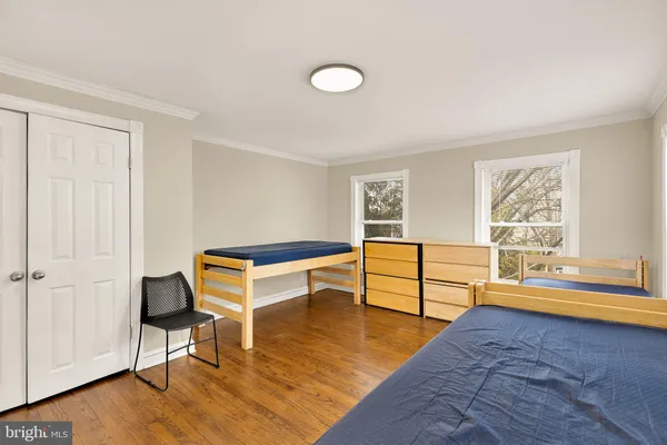 a bedroom with furniture and a window