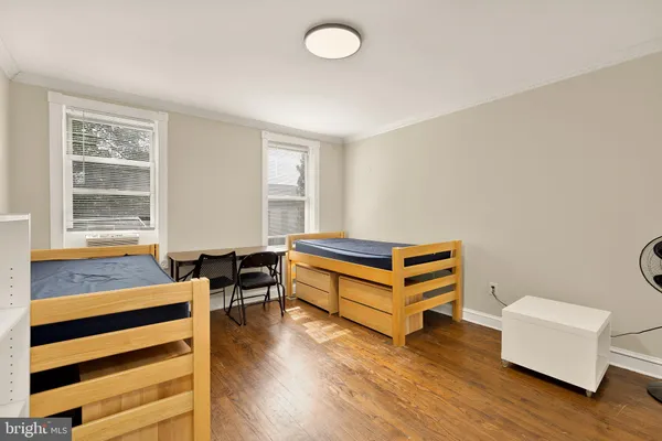 a bedroom with furniture and a window