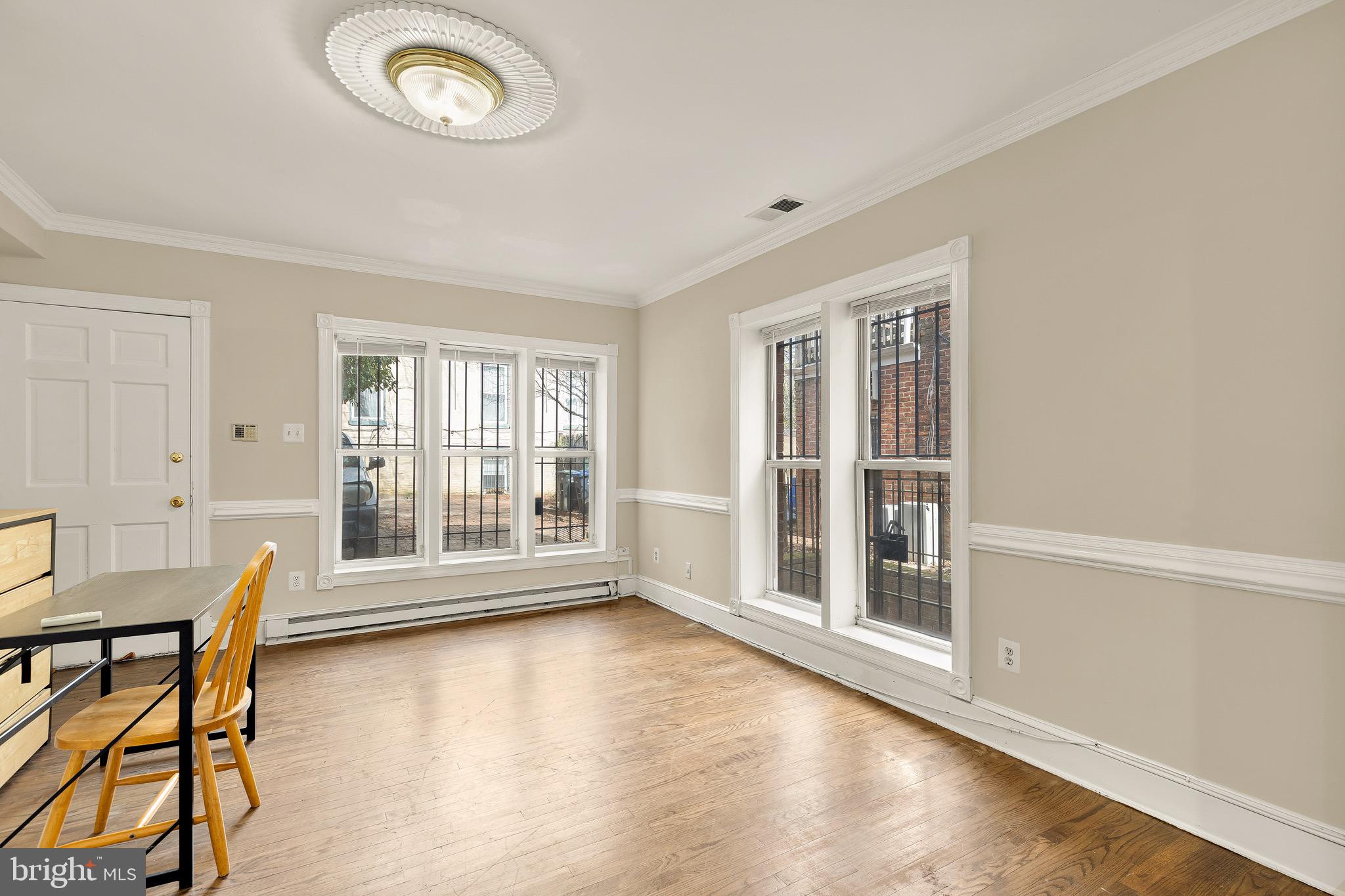 228 East Capitol Street Northeast Washington, DC 20003 - Photo 9 of 27 a view of an empty room with a window and wooden floor