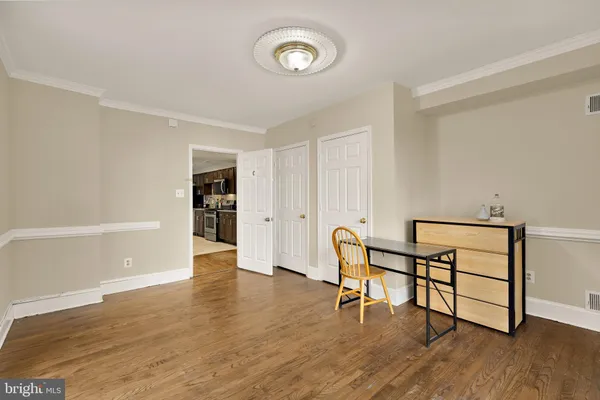 a view of a room with wooden floor lounge chair and windows