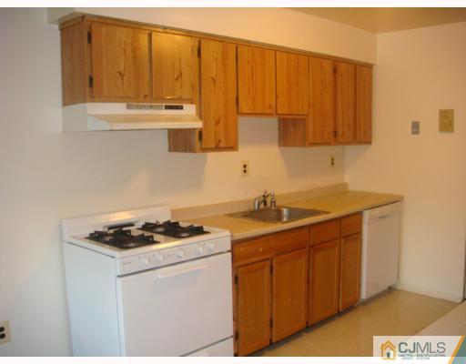 1630 Raspberry Court Edison, NJ 08817 - Photo 3 of 8 a kitchen with stainless steel appliances granite countertop a sink stove and cabinets